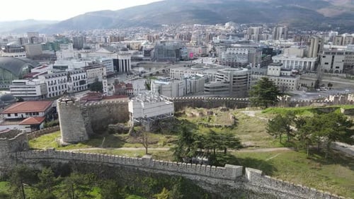 The castle in the center of Skopje is among the buildings, stone castle in the city center