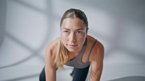 Young Adult Woman Doing Donkey Kick Exercise