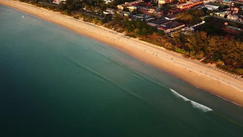 Aerial Footage of Long Seashore and Touristic Town Built Behind It