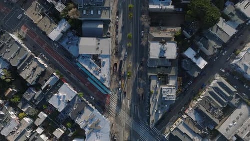 Fly Above Urban Borough at Golden Hour Vehicles Driving on Streets and Passing Through Intersections