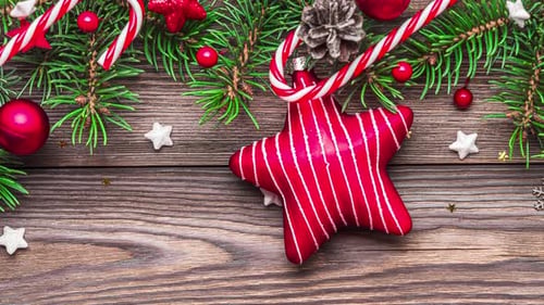 Christmas Background with Fir Tree Branches Gift Boxes Red Star and Decorations Candy and Pine Cones