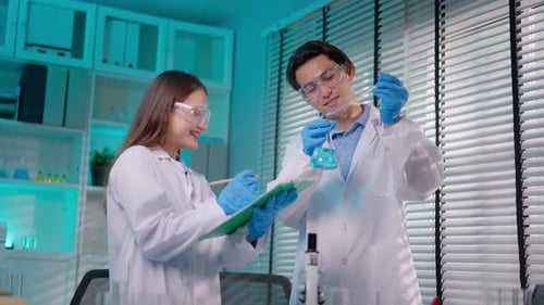 Asian male and female scientists work together in the research laboratory.