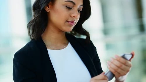 Young Woman Using Smartphone in Modern Workplace