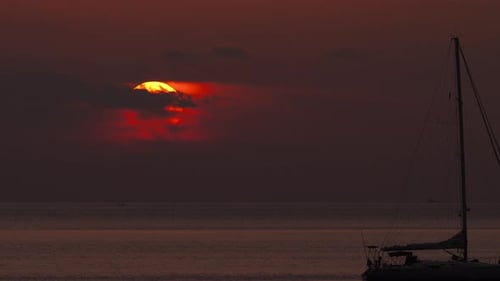 Sailing Yacht Against a Cloudy Sunset