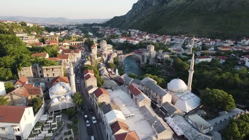 Aerial: Mostar cityscape with historic bridge and river, Bosnia