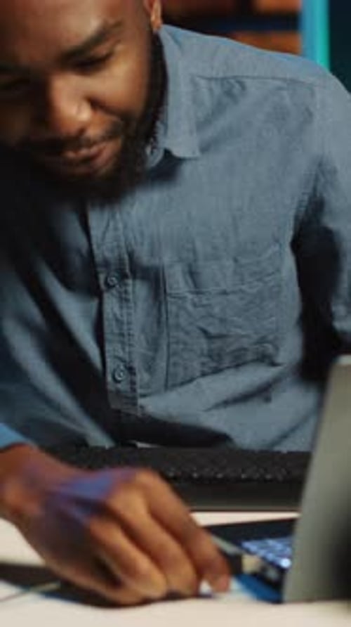 Man Shows Computer Keyboard with Colored Lights