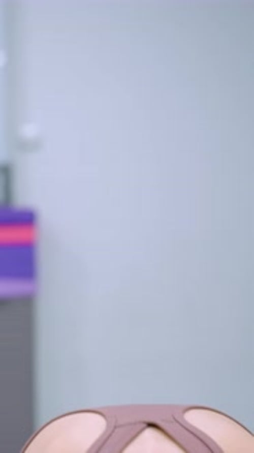 Young Woman Stretching and Exercising Indoors