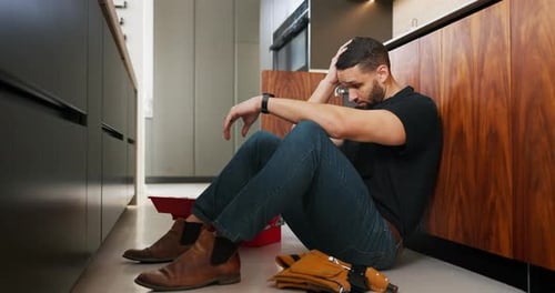 Plumbing, problem and stress with man in kitchen of home for maintenance or repair project