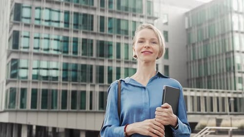 Confident Business Woman Walking Outdoors a Modern Office Building