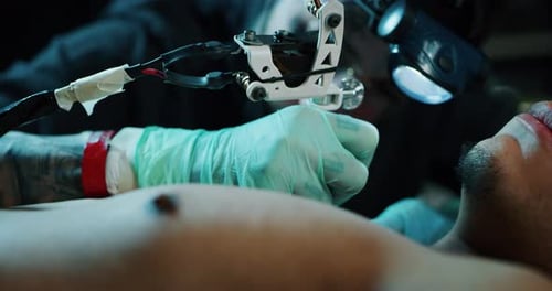 Milan/Italy-01.02.2019:Slow motion of professional master of the art of tattooing doing a tattoo t