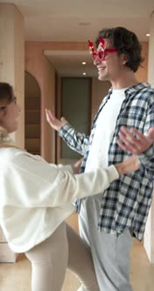 Happy Couple Wearing Festive Holiday Glasses and Headband