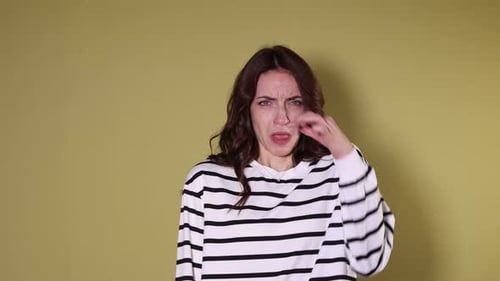 Woman suffering from bad smell on yellow background