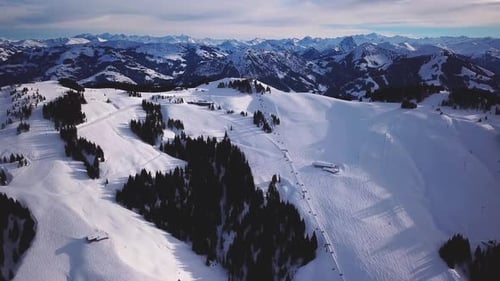 Aerial view of People Skiing and snowboarding on hill, Ski Resort. Drone flies over Skiers Skiing do