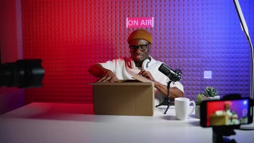 Man unboxing a new phone in his studio