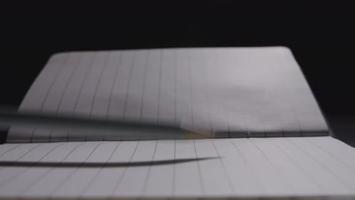Close up of pencil slamming on the notebook