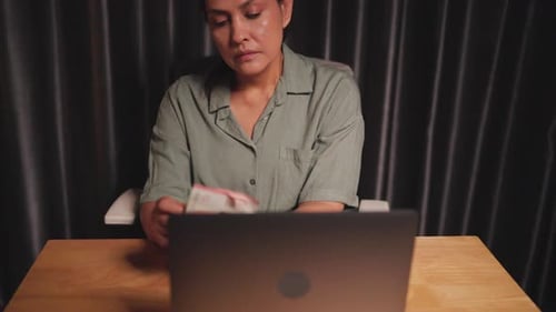 Stressed Asian businesswoman counting savings for future investment, economic downturn and slowdown,