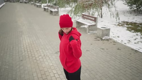 Woman in Red Standing Outside on Winter Day
