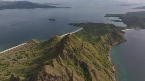 Aerial view of sunny Padar Island seascape with cliff coastline, Indonesia.