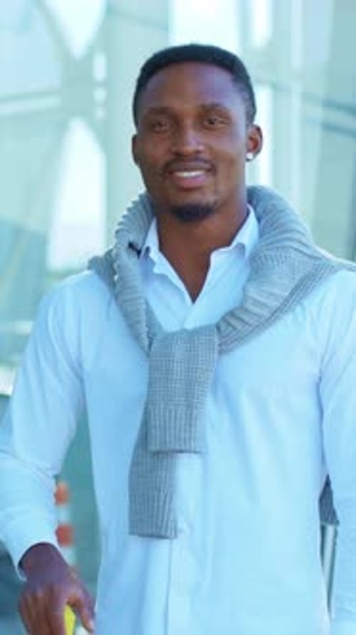 A Stylish Traveler with Luggage at a Modern Airport Capturing the Essence of Contemporary Travel