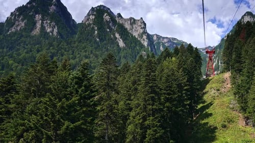 Scenic Mountains and Evergreen Forests with Cable Car