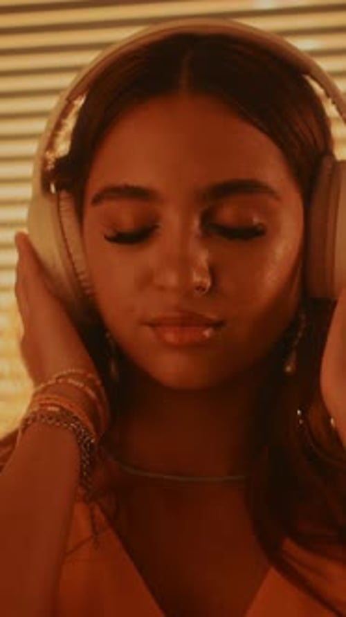 Smiling Woman Listening to Music with Headphones