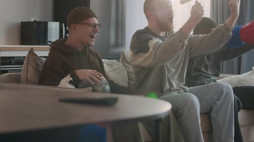 Friends Cheering, Watching Sports in Living Room