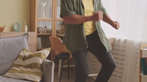Senior Man Dancing to Music at Home