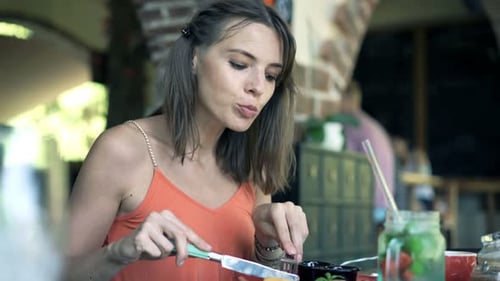 Happy Woman Enjoying Lunch at Cafe