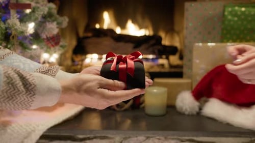 Close Up Shot Male Hands Giving Elegant Lack Box with Red Bow to Woman Christmas