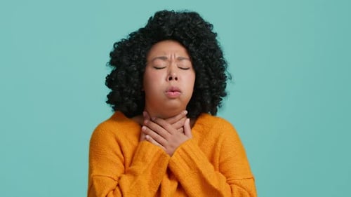 Woman Experiencing Throat Pain in Close Up