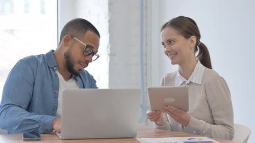 Colleagues Work Together in Modern Office