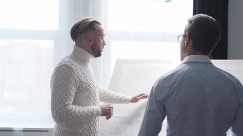 Architect and His Colleague Work in Loft Using Drawing Board Workplace of Young Engineer in Modern
