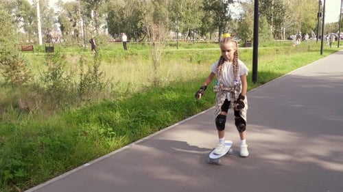 Girl on a Skateboard in a City Park