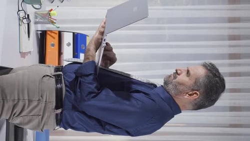 Mature Man Using Laptop at Standing Desk