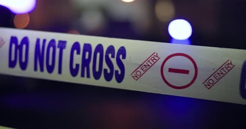 Crime Scene Tape at Night with Flashing Lights