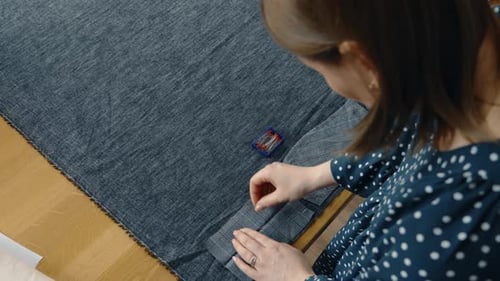 Woman Tailoring Clothes on a Sewing Table