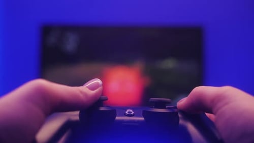 Close up of gamer's hands playing a video game