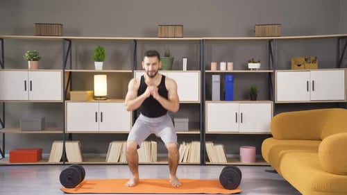 Athlete man doing cardio exercises at home.