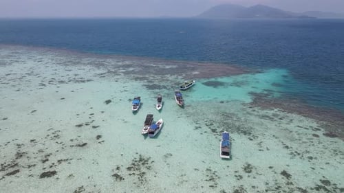 Top view or aerial view of beautiful clear water and white beach with long tail boats on summer trop