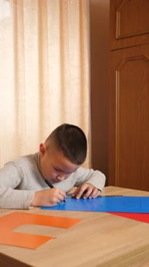 Young Boy Drawing at Table Indoors