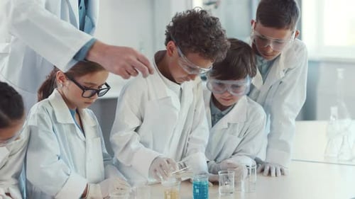 Students Learn Science with Teacher in Classroom Laboratory