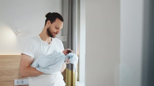 Father His Cute Newborn Baby Boy in Hospital Room Handsome Dad Carrying His