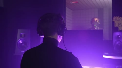 Audio Engineer Controlling the Song Recording in Music Studio