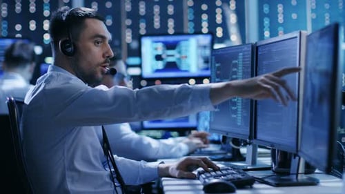 In the System Control Center Technical Support Team Gives Instructions with the Help of the Headset