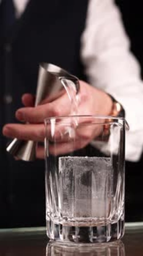 the bartender prepares a popular cocktail at the bar