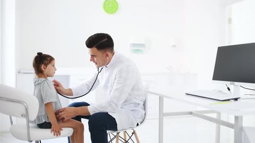 Doctor Examines Child with Stethoscope in Clinic