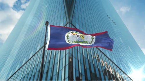 Belize National Flag Waving in Front of Modern Corporate Building