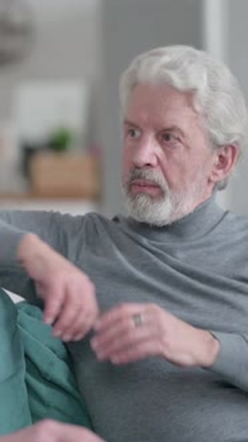 Mature Man With Gray Hair Talking Indoors