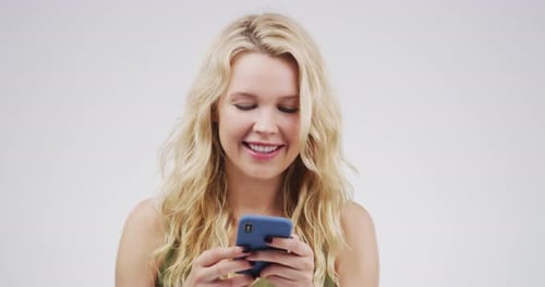Blonde Woman Using Smartphone and Smiling