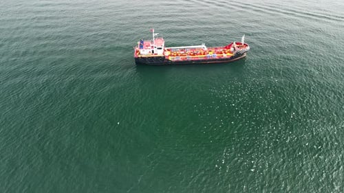 Focused drone shot of a red boat